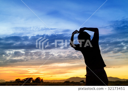 silhouette of woman and beautiful twilight with sunset silhouette of woman and beautiful twilight with sunset 32173451