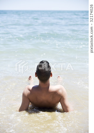 young man on the beach 32174026