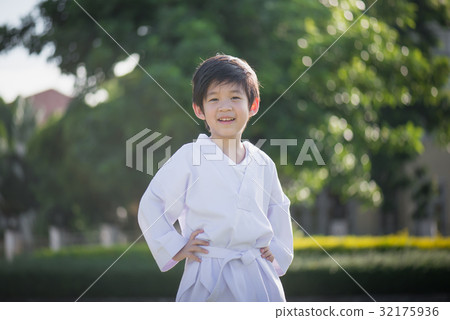 Asian child in white kimono during training karate 32175936