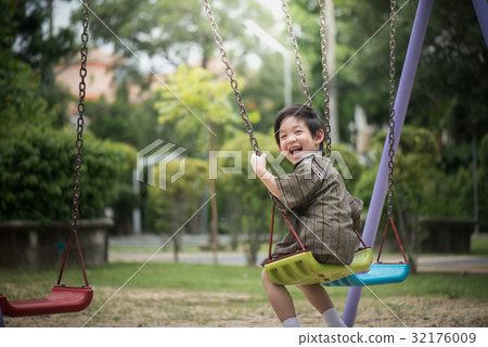 Asian child in kimono playing on swing i Asian child in kimono playing on swing i 32176009