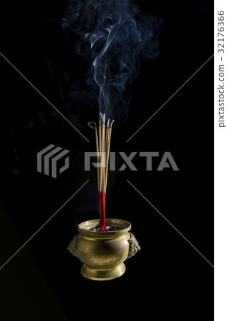Incense sticks are burning in incense pot Incense sticks are burning in incense pot 32176366