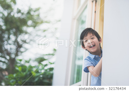 cute Asian child at the open window 32176434