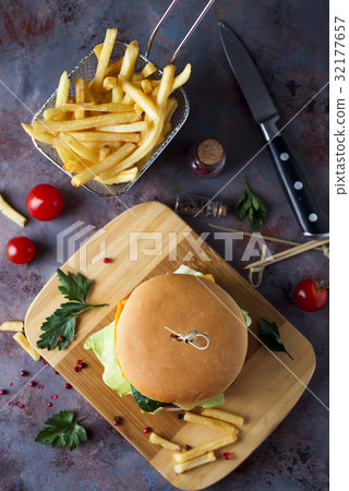 Hamburger with french fries, beer on a stone table Hamburger with french fries, beer on a stone table 32177657