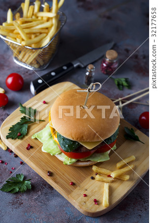 Hamburger with french fries, beer on a stone table 32177658