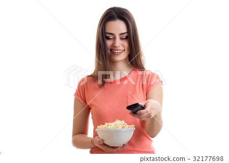 charming lady with pop corn in hand smiling and charming lady with pop corn in hand smiling and 32177698