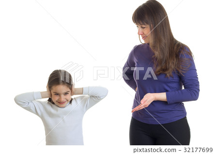 little girl standing next to her mother and closes little girl standing next to her mother and closes 32177699