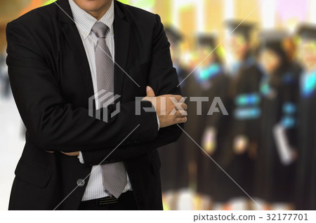 Young businessman standing on the back of Peoples 32177701