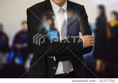 Young businessman standing on the back of Peoples 32177702