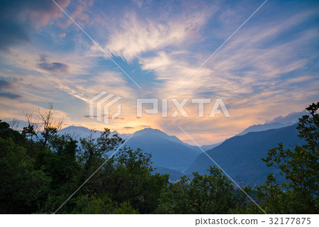 Soft pastel colored sky over rocky mountain peaks 32177875