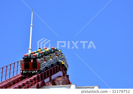 Roller coaster climbing up a chain lift 32179752