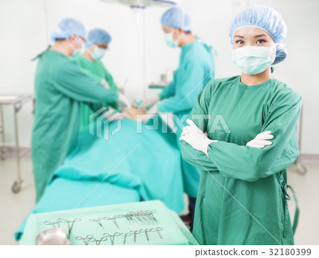 surgeon standing in a surgical room 32180399