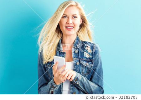 Young woman using her phone Young woman using her phone 32182705