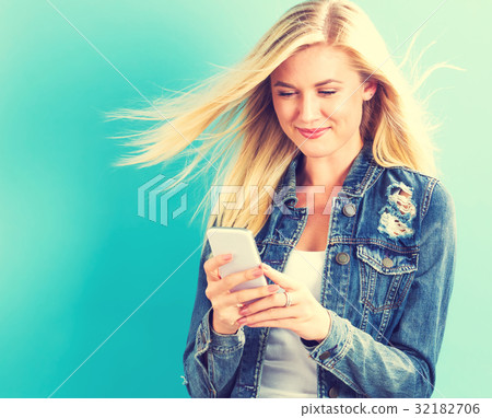 Young woman using her phone Young woman using her phone 32182706