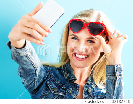 Young woman taking a selfie 32182708