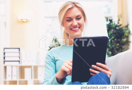 Young woman using her tablet computer 32182894