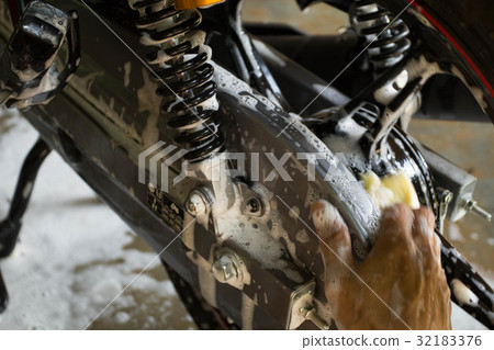 washing a motorcycle wheel by hand washing a motorcycle wheel by hand 32183376