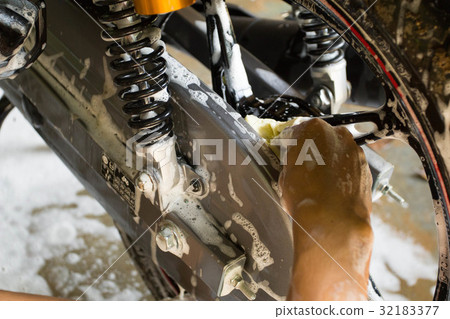 washing a motorcycle wheel by hand 32183377