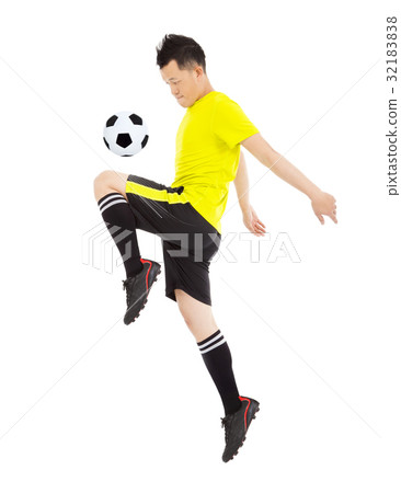 soccer player jumping to stop the ball 32183838
