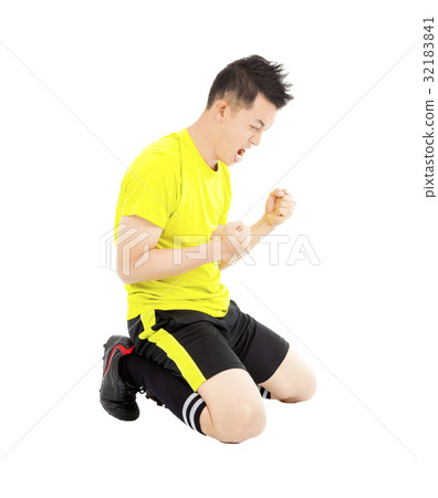 young soccer player make a fist and yell young soccer player make a fist and yell 32183841