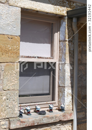 old window in an ancient stone wall  32191442