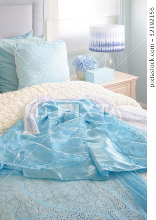 Light blue princess dress on bed in bedroom 32192156
