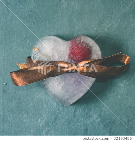 Heart shaped ice cubes with frozen cherry 32193496