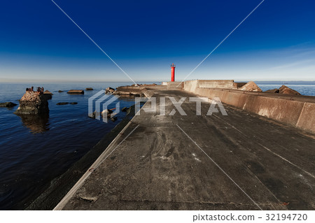 Red lighthouse on breakwater dam Red lighthouse on breakwater dam 32194720