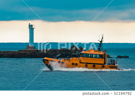 Orange pilot ship moving at speed 32194792