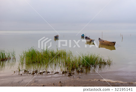 Old rowboats on the lake at sunset 32195141