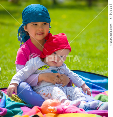 Toddler girl with her newborn baby brother Toddler girl with her newborn baby brother 32195541