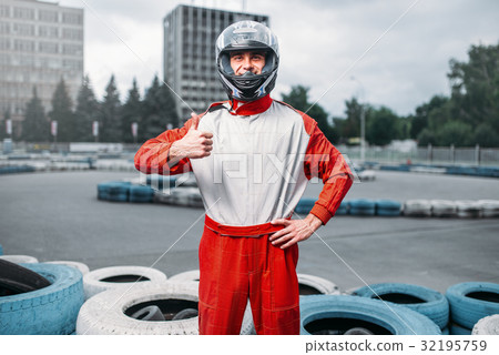 Kart driver in helmet, karting track on background Kart driver in helmet, karting track on background 32195759