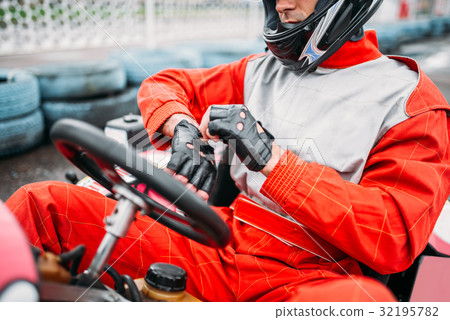 Go-kart driver in helmet on karting speed track 32195782