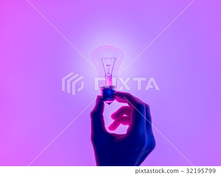 Female hand and holding luminous light bulb. Female hand and holding luminous light bulb. 32195799