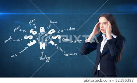 Beauty girl in a suit standing near wall with a 32196382