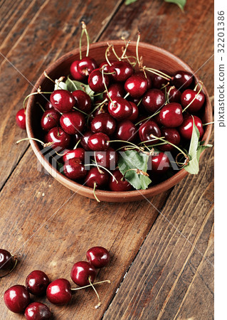 Juicy ripe cherries on a wooden table 32201386