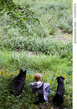 young woman texting on the phone with two black 32204424