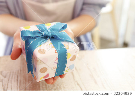 Blue ribbon gifts and women's hands 32204929