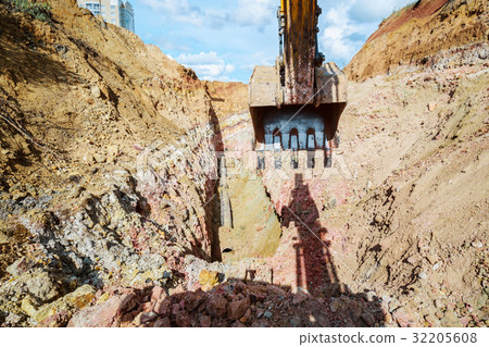 Excavator digging a trench for the pipeline.  32205608