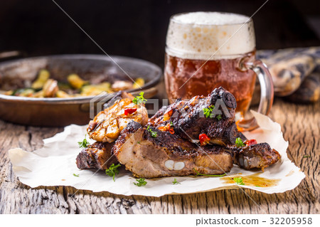 Juicy roasted pork ribs with on rustic oak table 32205958