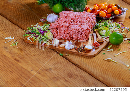 Minced beef raw on wood table with herbs and spice 32207395