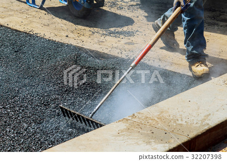 Workers on Asphalting paver during Road street  32207398