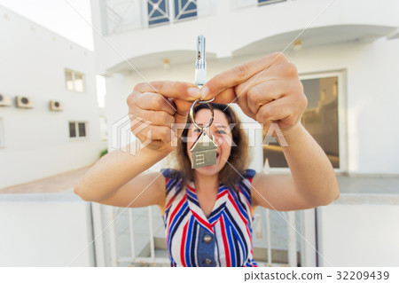 Happy young woman In Front of New Home with New 32209439