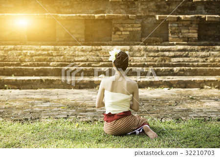 Asian lady in custom sit in front of old stupa Asian lady in custom sit in front of old stupa 32210703
