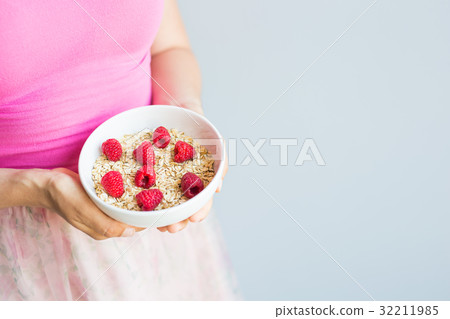 Woman's hands hold healthy and natural breakfast Woman's hands hold healthy and natural breakfast 32211985