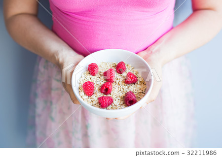 Woman's hands hold healthy and natural breakfast Woman's hands hold healthy and natural breakfast 32211986