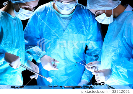 Medical team performing operation. Group of 32212061