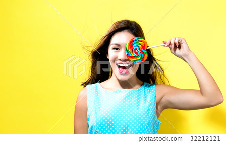 Young woman holding a lollipop Young woman holding a lollipop 32212121