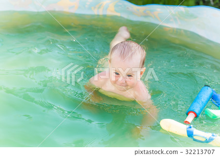 Baby swims in a plastic pool in the nature Baby swims in a plastic pool in the nature 32213707