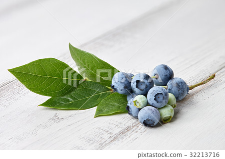 Blueberry branch close up on wooden background Blueberry branch close up on wooden background 32213716