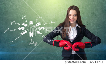 Woman in red boxing gloves standing near wall with Woman in red boxing gloves standing near wall with 32214711